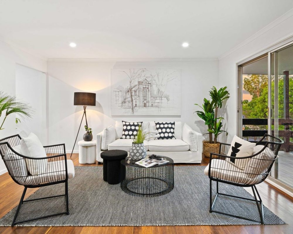 Sophisticated living space with neutral palette and open balcony access