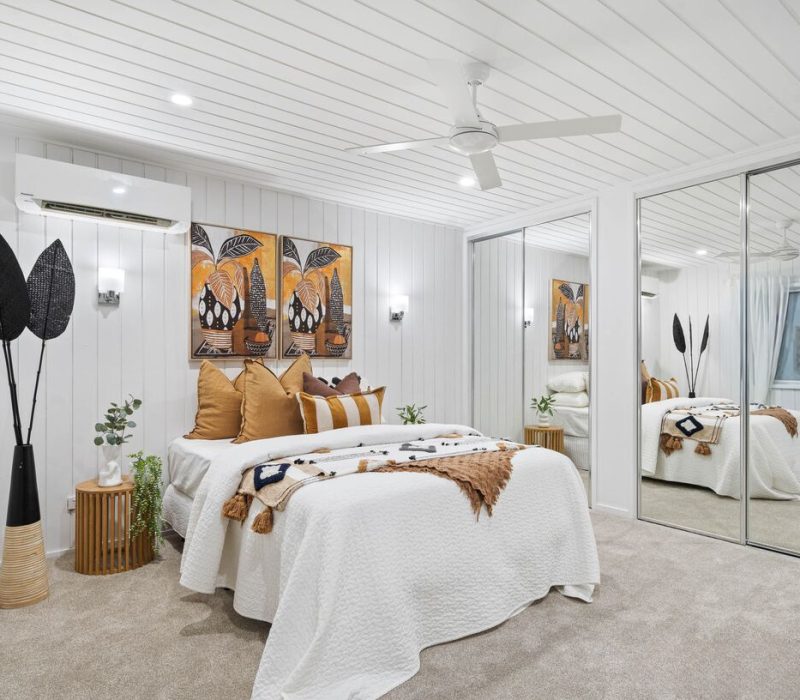 Interior designed bedroom with bold wall art and textured decor