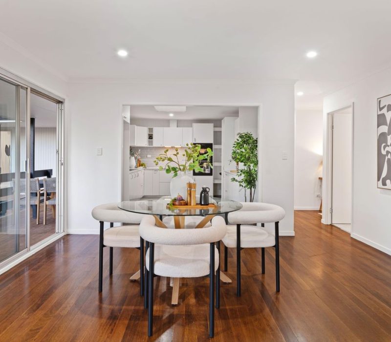 Dining room with interior design connection to kitchen and natural tones