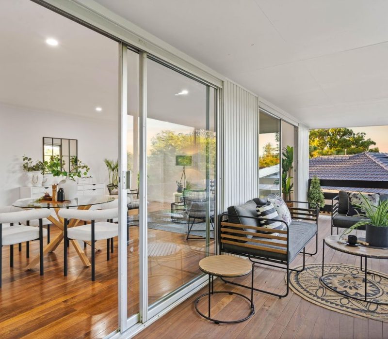 Outdoor covered patio with timber decking and garden views