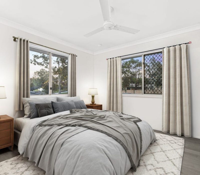 Contemporary bedroom design with soft curtains and dual windows