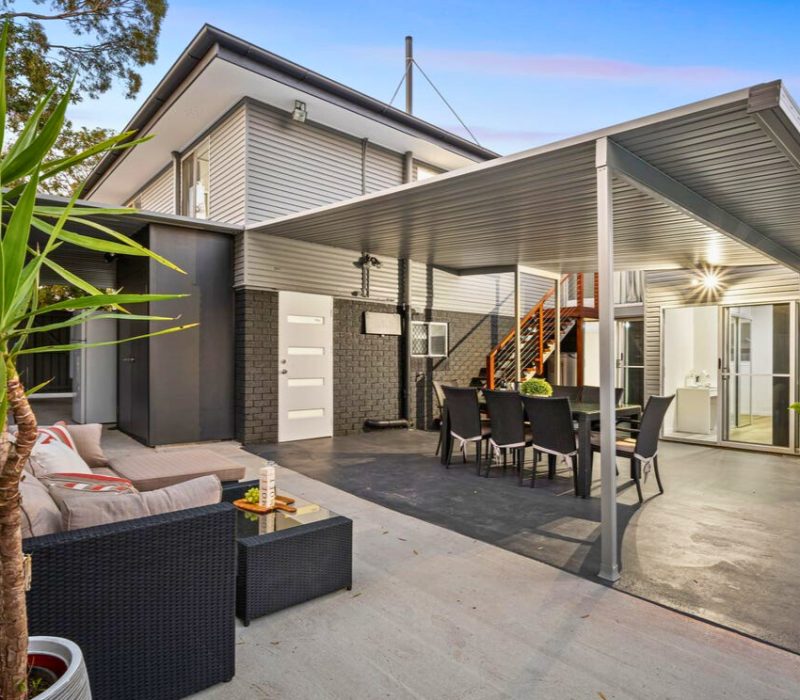 Poolside covered patio with outdoor lounge and dining setting